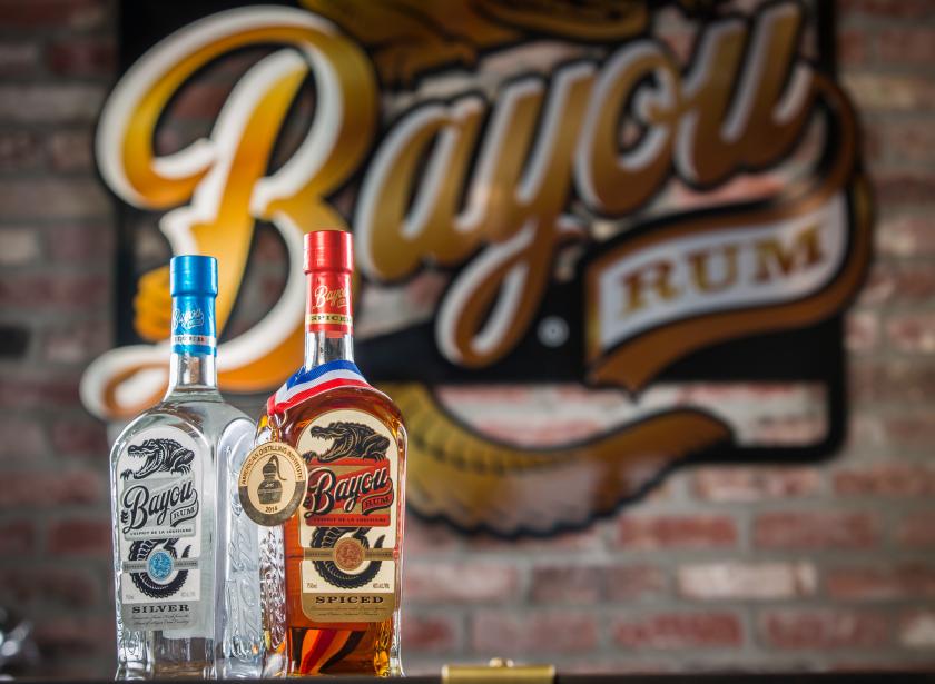 Bayou Rum Bottle Setup Bottles of white and dark rum against a brick wall at Bayou Rum in Lacassine, Louisiana.